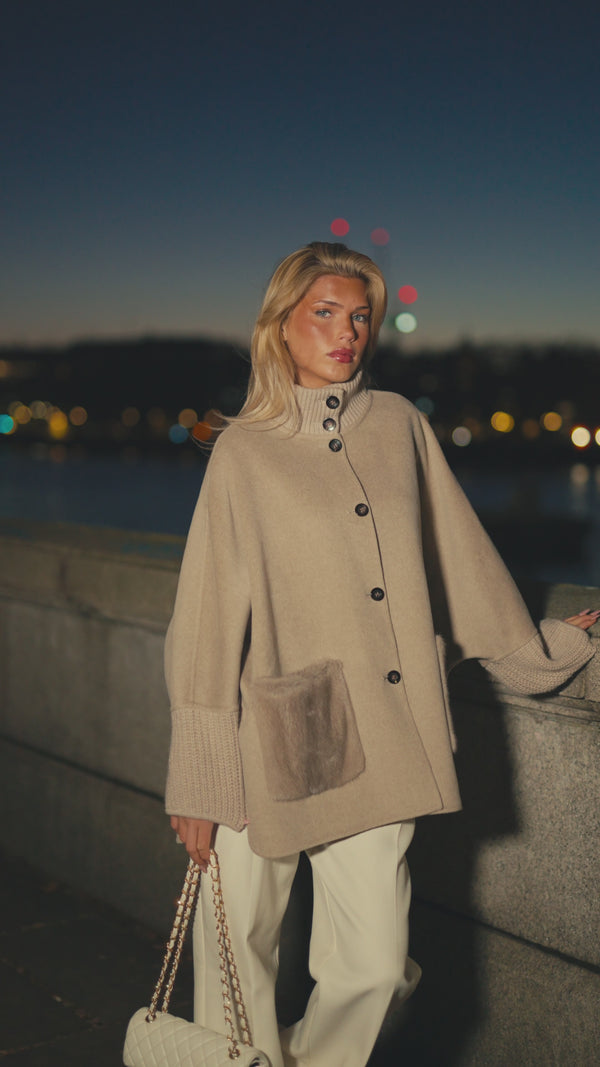 The Reem mink cashmere coat in sandstone, worn by Westminster at night
